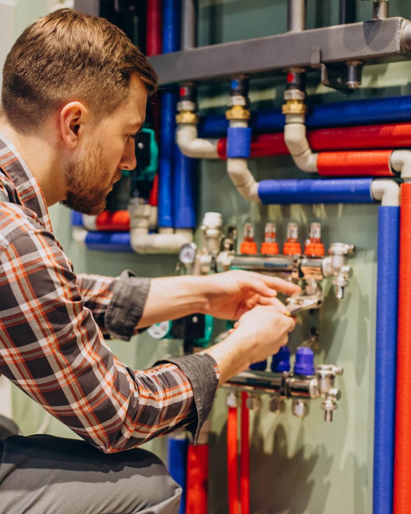 Young engineer adjusting autonomous heating